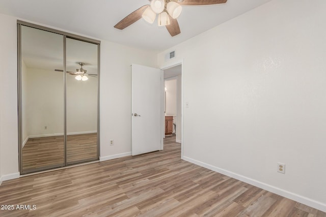 1047 W Laguna Dr, Tempe, AZ 85282 - unfurnished bedroom with light wood-style floors, a closet, baseboards, and a ceiling fan