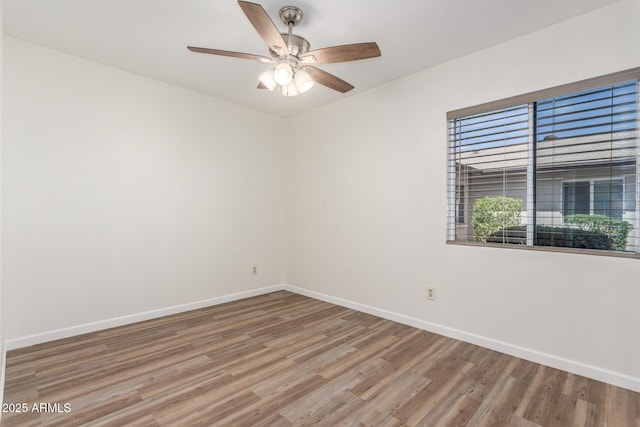 1047 W Laguna Dr, Tempe, AZ 85282 - spare room with baseboards, wood finished floors, and a ceiling fan