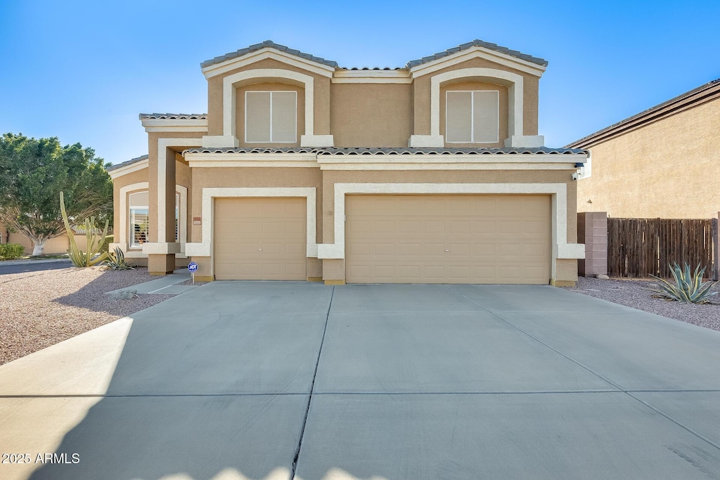 mediterranean / spanish home featuring a garage