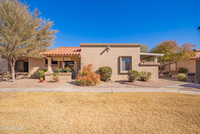 adobe home with a front yard