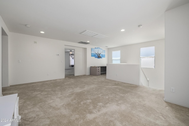 unfurnished room with light carpet, visible vents, and recessed lighting