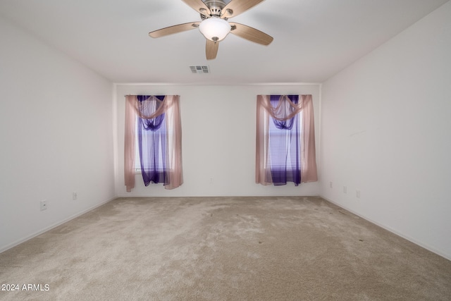 unfurnished room featuring carpet and ceiling fan