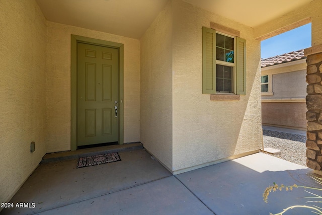 entrance to property featuring stucco siding