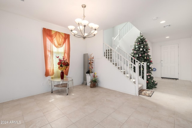 tiled entrance foyer with a chandelier