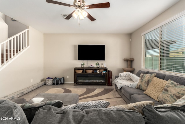 tiled living room with ceiling fan