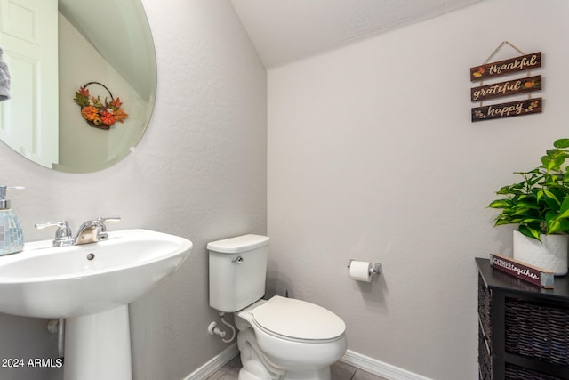 bathroom with sink, tile patterned floors, and toilet