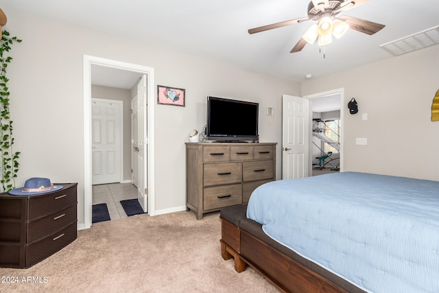 bedroom featuring ceiling fan and light carpet