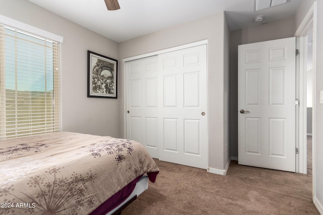 carpeted bedroom with a closet and ceiling fan