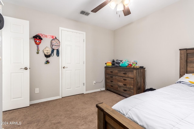 bedroom featuring ceiling fan and light carpet