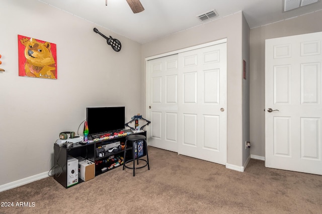 office space with ceiling fan and carpet