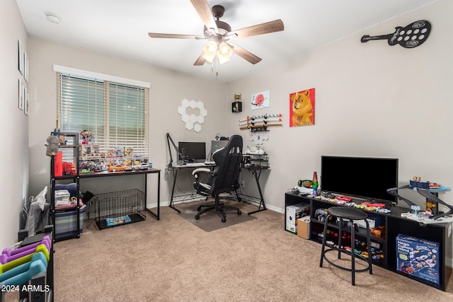 carpeted office featuring ceiling fan