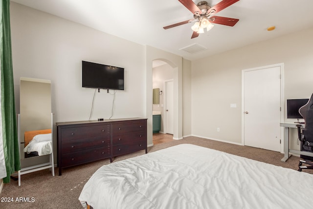 bedroom featuring carpet, ensuite bathroom, and ceiling fan