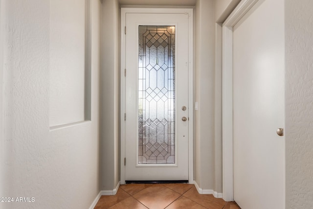 doorway featuring light tile patterned flooring