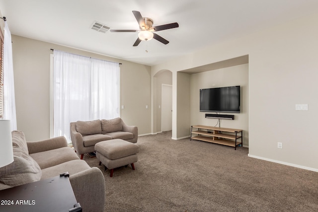 carpeted living room featuring ceiling fan