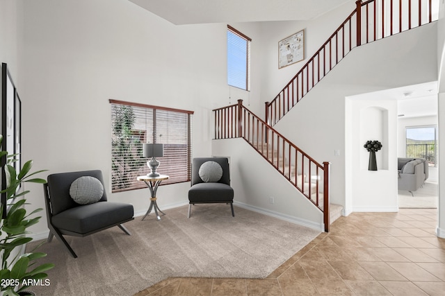 31221 N 130th Ln, Peoria, AZ 85383 - sitting room featuring a high ceiling, stairs, carpet flooring, baseboards, and tile patterned floors