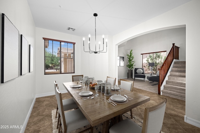 31221 N 130th Ln, Peoria, AZ 85383 - dining room featuring baseboards, arched walkways, stairway, and a chandelier