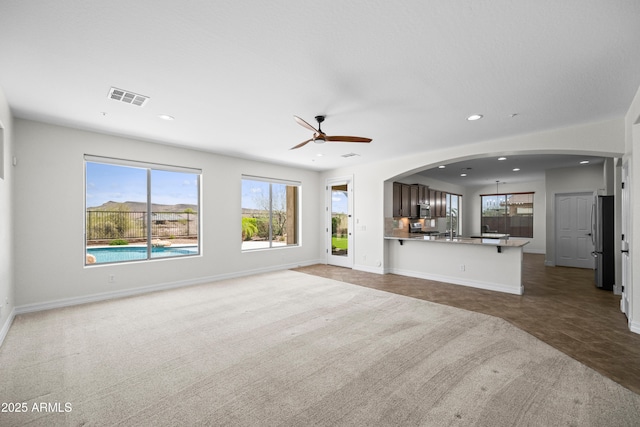 31221 N 130th Ln, Peoria, AZ 85383 - unfurnished living room featuring recessed lighting, healthy amount of natural light, ceiling fan, carpet flooring, and baseboards