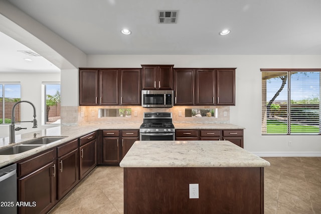 31221 N 130th Ln, Peoria, AZ 85383 - kitchen with appliances with stainless steel finishes, a sink, decorative backsplash, dark brown cabinets, and recessed lighting