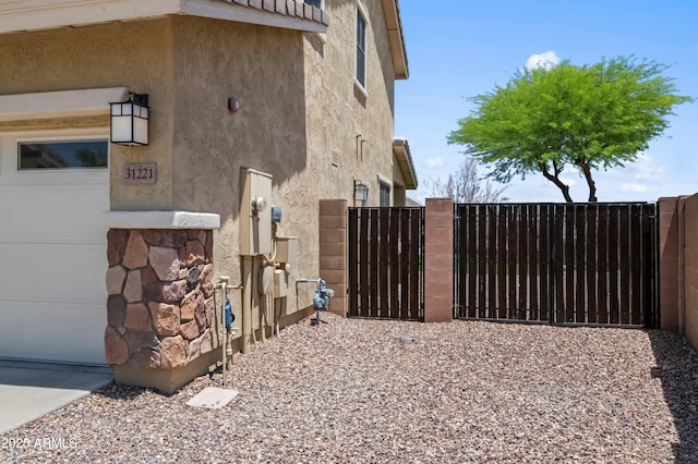 31221 N 130th Ln, Peoria, AZ 85383 - view of side of home with a gate and stucco siding