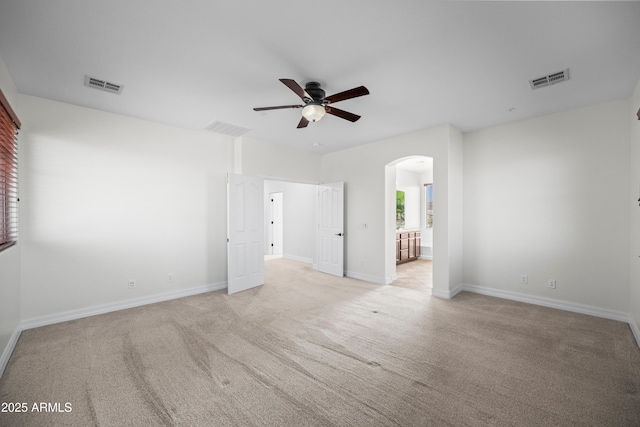 31221 N 130th Ln, Peoria, AZ 85383 - empty room featuring arched walkways, a ceiling fan, light colored carpet, and baseboards