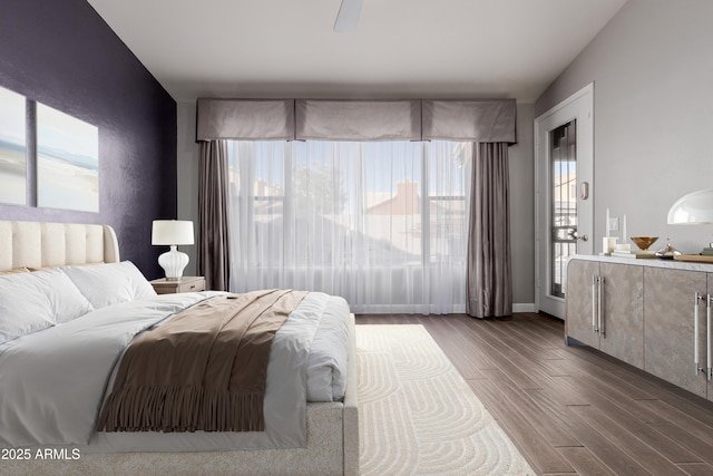 bedroom featuring baseboards and dark wood-style flooring