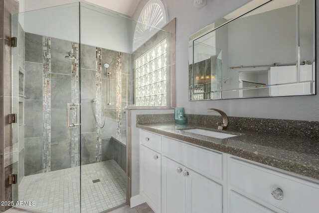 bathroom with vanity and a shower stall