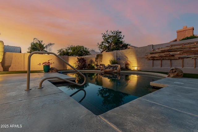 view of pool with a fenced in pool, a fenced backyard, and a patio area