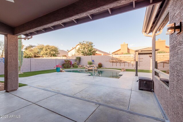 view of patio with a fenced in pool and a fenced backyard