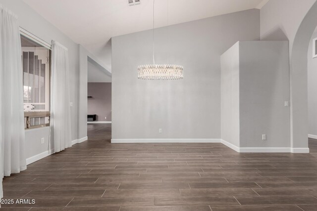 unfurnished dining area with a notable chandelier, baseboards, and wood finish floors