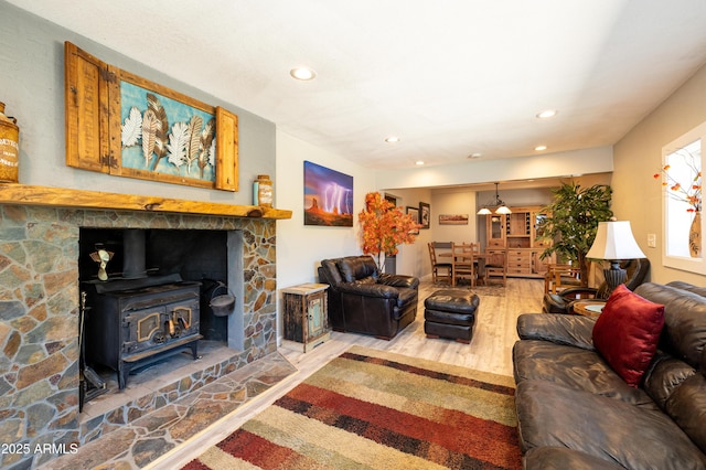 living room with wood-type flooring and a wood stove