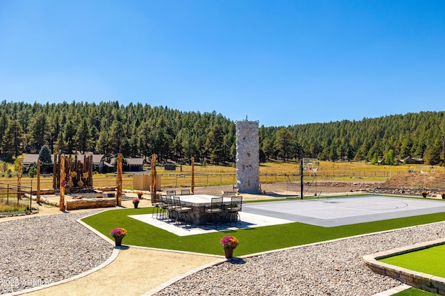 view of basketball court with a lawn