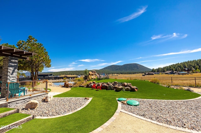 view of yard with a mountain view and a rural view