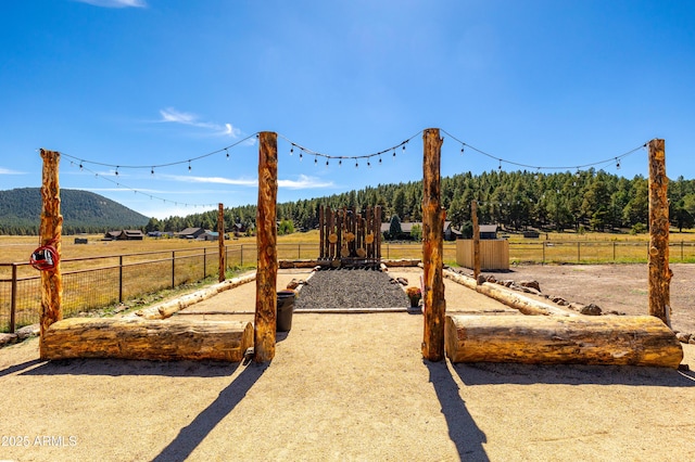 view of yard with a mountain view and a rural view