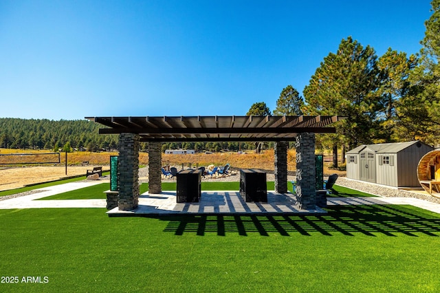 view of property's community with a storage unit and a lawn