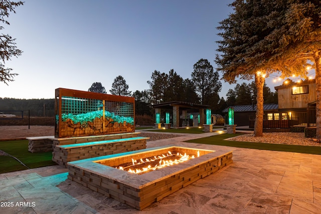 exterior space with a gazebo, an outdoor fire pit, and a patio