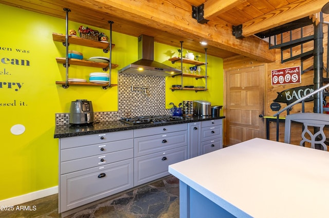 kitchen with wood ceiling, beamed ceiling, stainless steel gas stovetop, range hood, and decorative backsplash