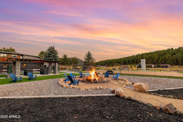 playground at dusk with a fire pit