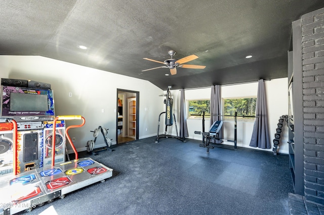 workout room with vaulted ceiling and a textured ceiling