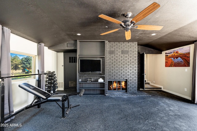 workout area with a fireplace, carpet, a textured ceiling, and vaulted ceiling