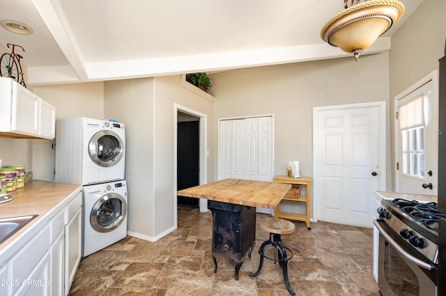 washroom featuring stacked washer / dryer