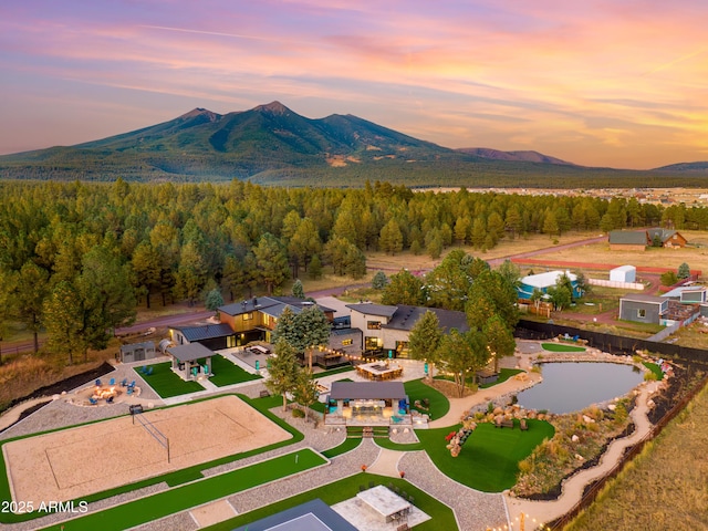 aerial view at dusk featuring a mountain view