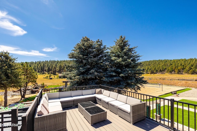 wooden terrace with a rural view and an outdoor hangout area