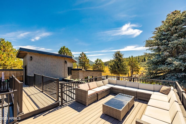 wooden terrace with outdoor lounge area