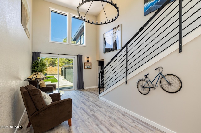 foyer entrance with a towering ceiling and light hardwood / wood-style flooring