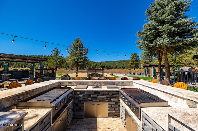 view of patio featuring area for grilling, a gazebo, and exterior kitchen