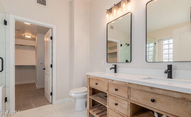 20929 N 37th Way, Phoenix, AZ 85050 - bathroom with double vanity, toilet, a spacious closet, a shower with shower door, and tile patterned flooring