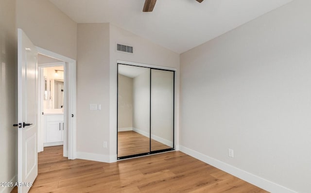 20929 N 37th Way, Phoenix, AZ 85050 - unfurnished bedroom featuring light wood-style flooring, vaulted ceiling, a closet, and baseboards