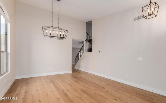 20929 N 37th Way, Phoenix, AZ 85050 - unfurnished dining area featuring a chandelier, stairs, light wood-style flooring, and baseboards