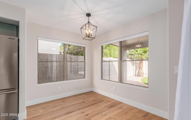 20929 N 37th Way, Phoenix, AZ 85050 - unfurnished dining area with a chandelier, baseboards, and light wood finished floors