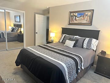 bedroom with carpet floors and a closet